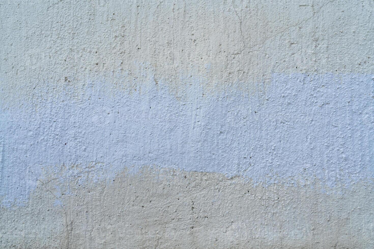 White and beige paint on the wall of a house. Construction and repair. photo