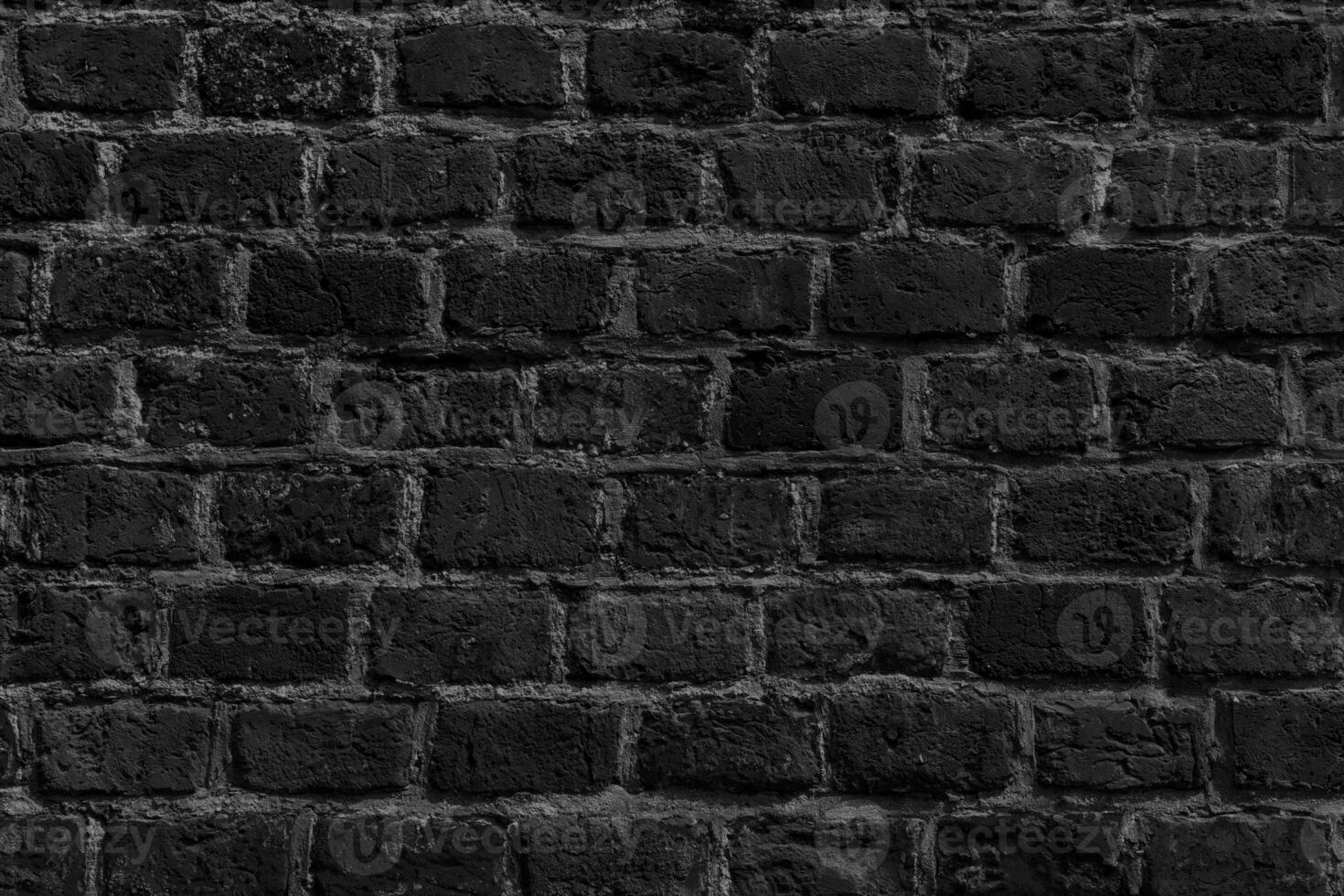 The background of the old black brick wall for design interior photo