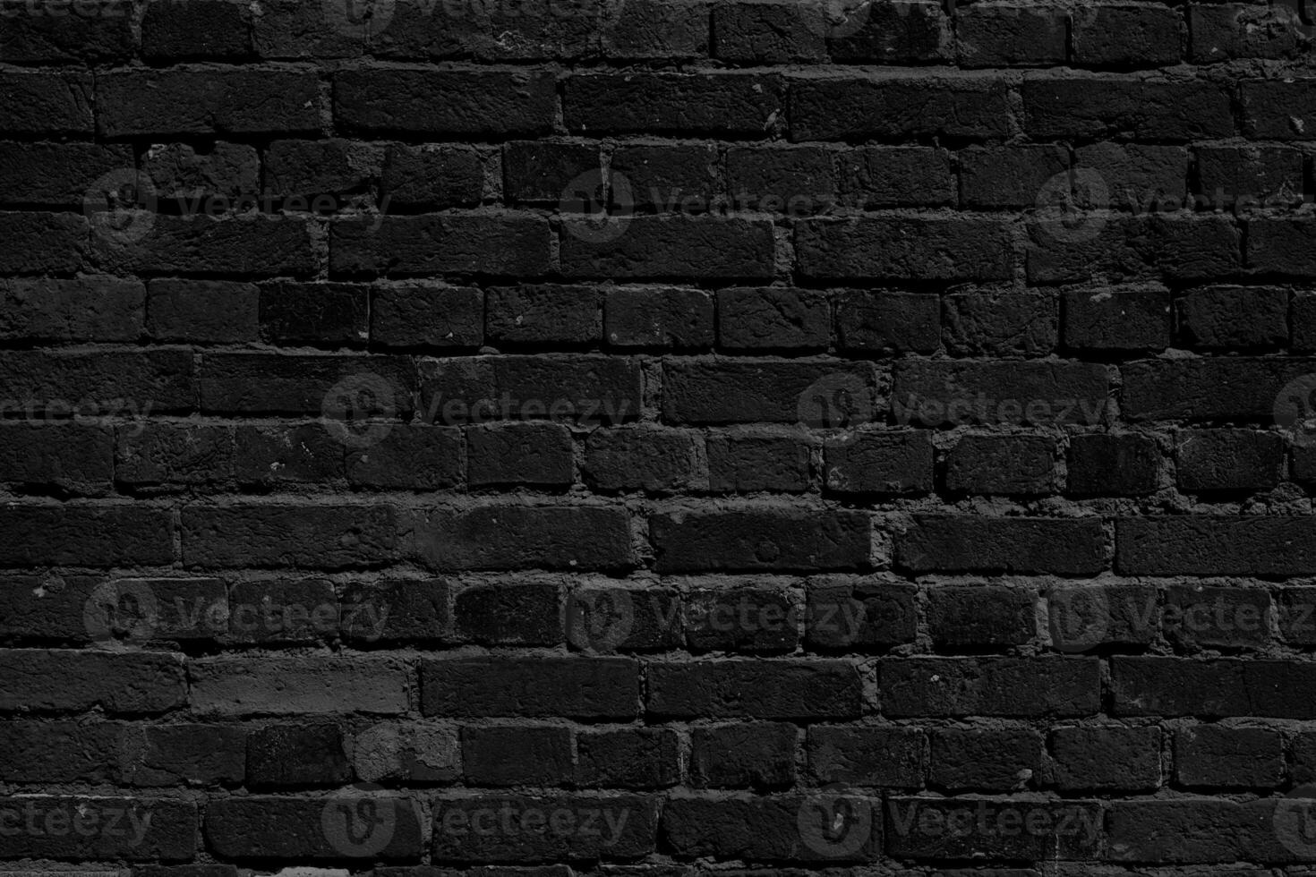 Black brick wall. Loft interior design. Black paint of the facade. photo