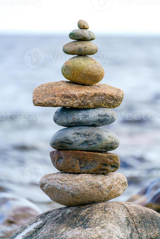 Pyramid of stones. Unstable balance of stone objects. Idyllic state of nature. photo