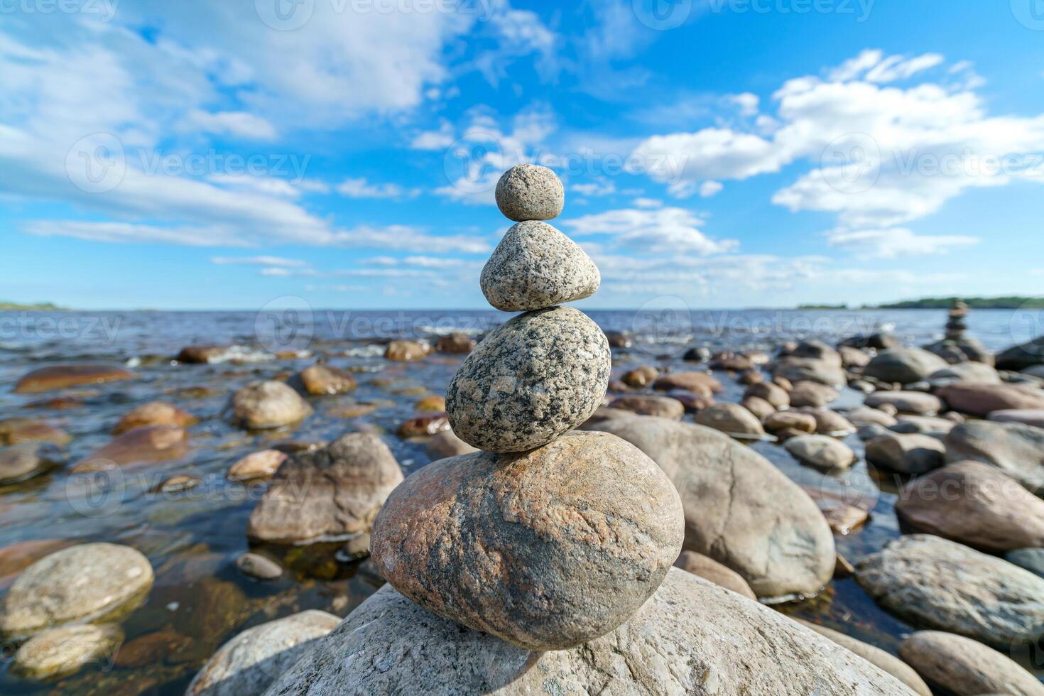 Pyramid of stones. Unstable balance of stone objects. Idyllic state of nature. photo