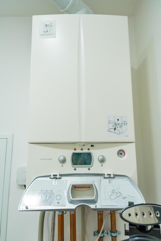 Osnice, Czech Republic - September 20, 2024. Wall-mounted boiler with open control panel in a home photo