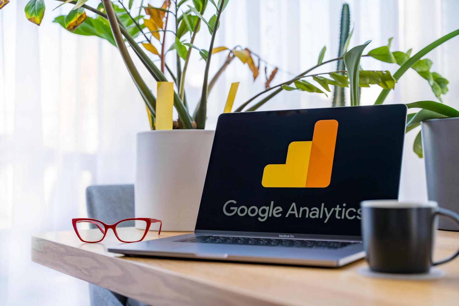 Prague, Czech Republic - September 20, 2024. Laptop with Google Analytics on screen at workspace photo