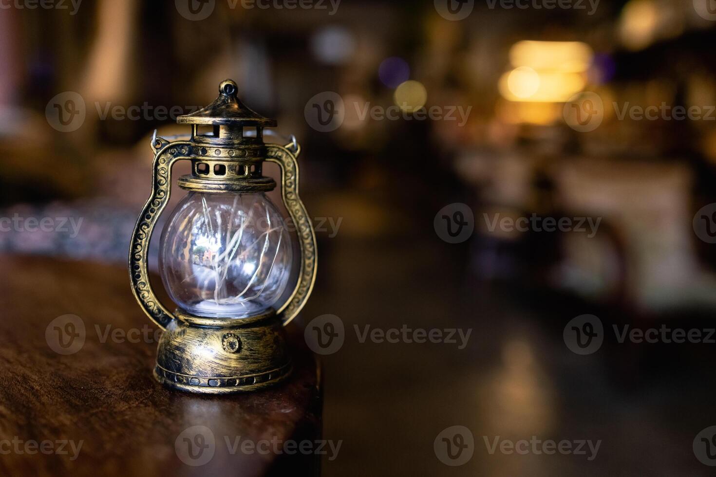 old vintage rusty kerosene black lamp isoleted on gray background. Glass oil lamp. photo