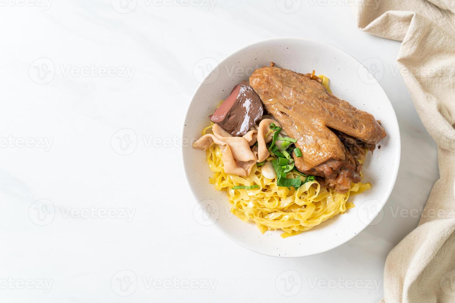 Egg noodles served dry with braised duck photo