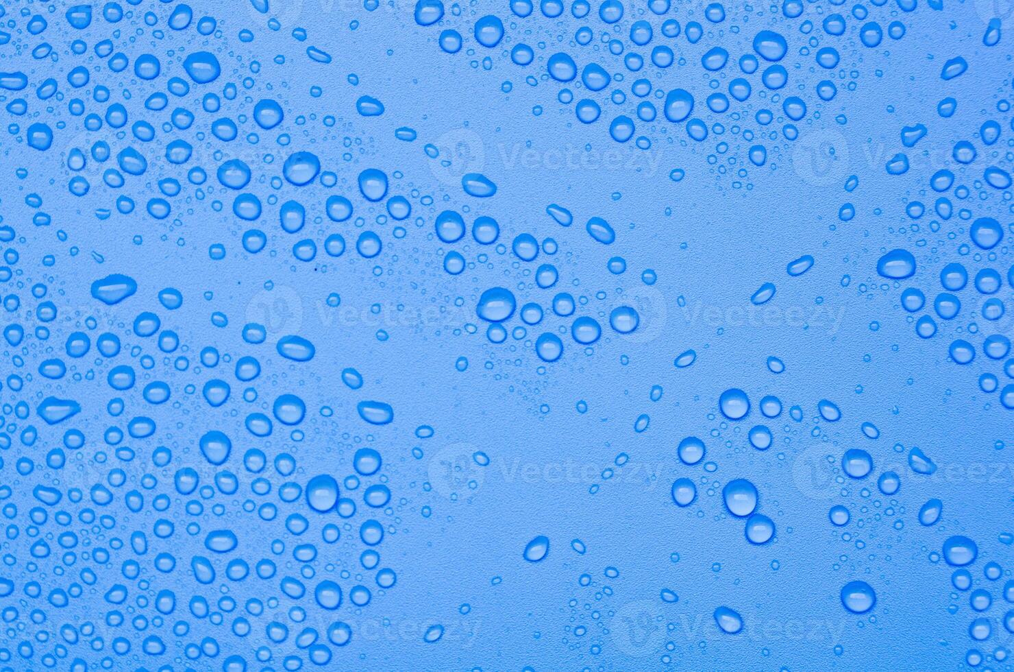 Top view of water droplets on blue gradient color cover background. Water droplets concept photo