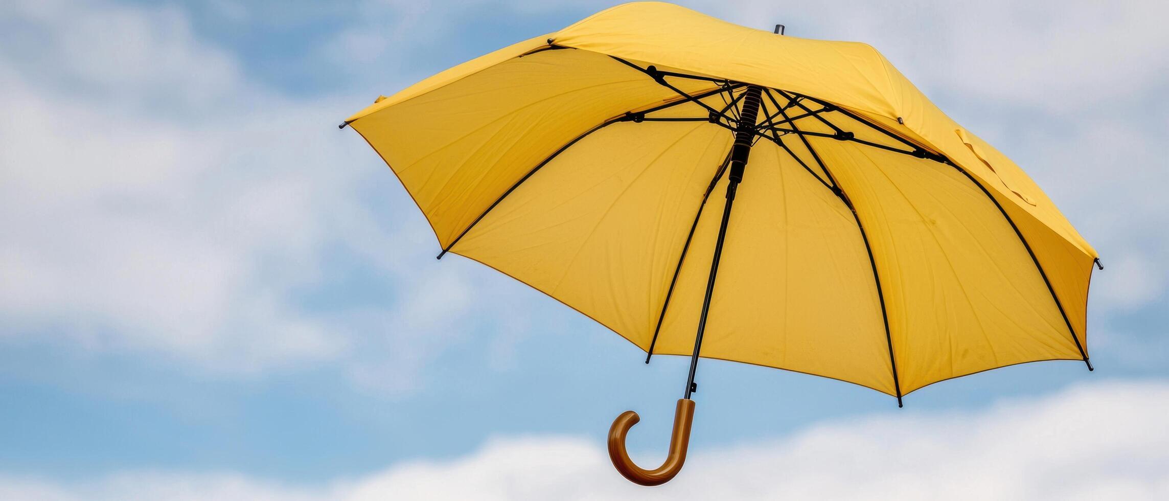yellow umbrella against blue sky photo