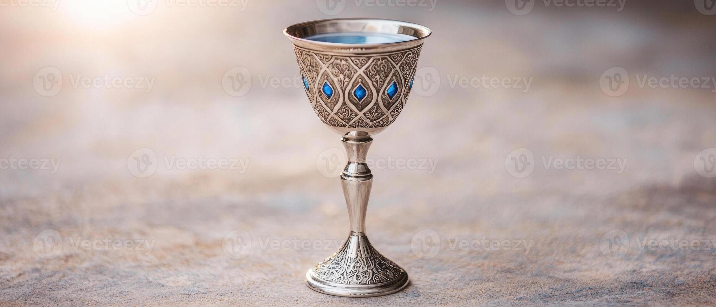 Ornate silver chalice with blue gemstones photo