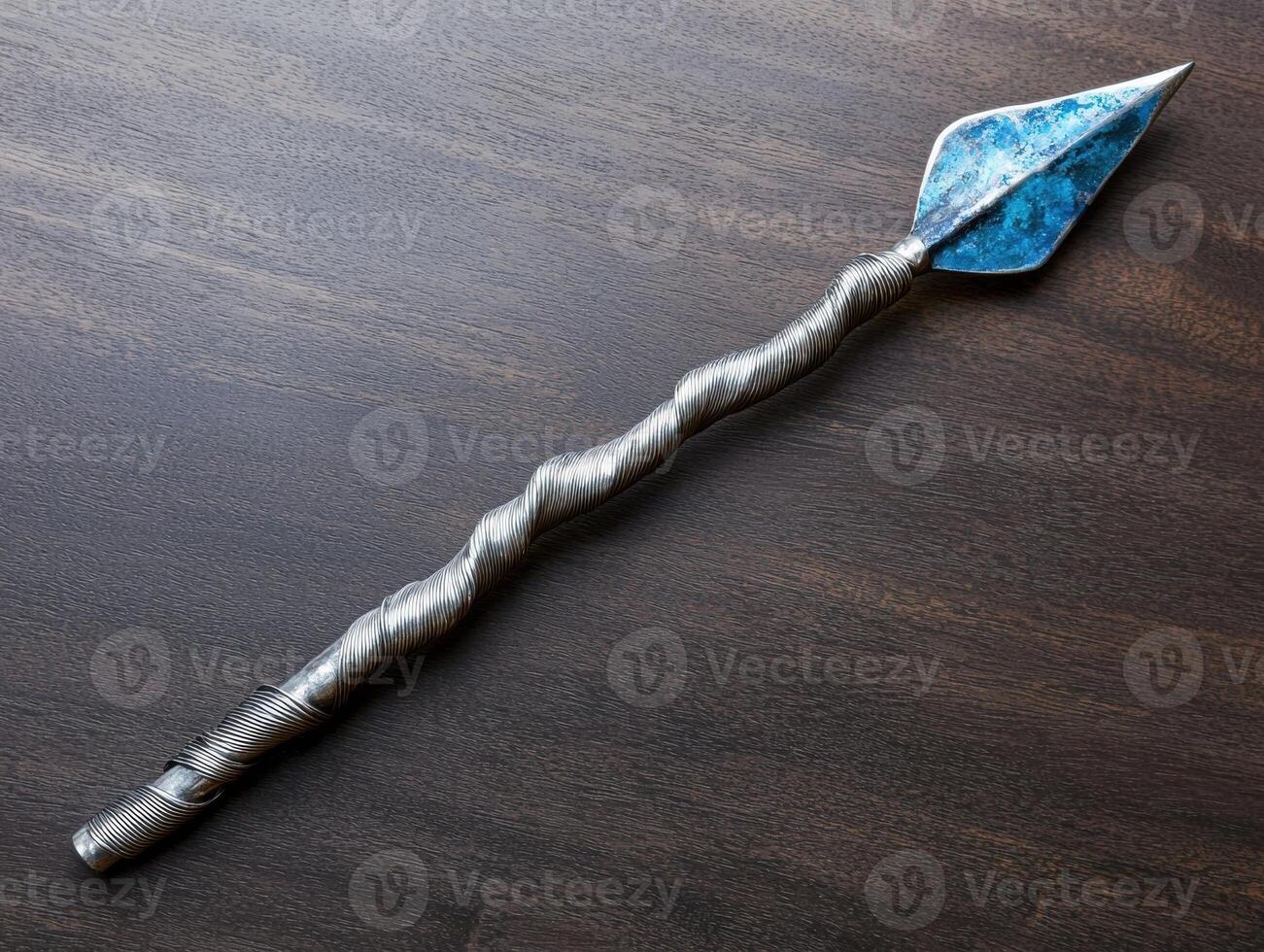 Unique metal tool on dark wooden surface photo