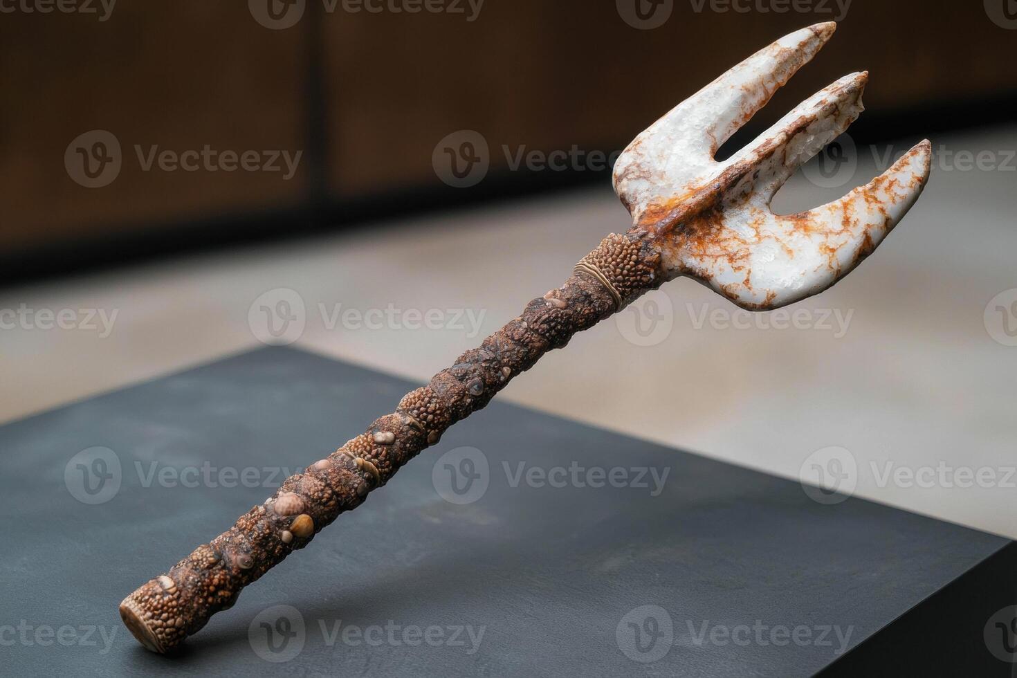 Antler shaped tool or artifact on dark surface photo