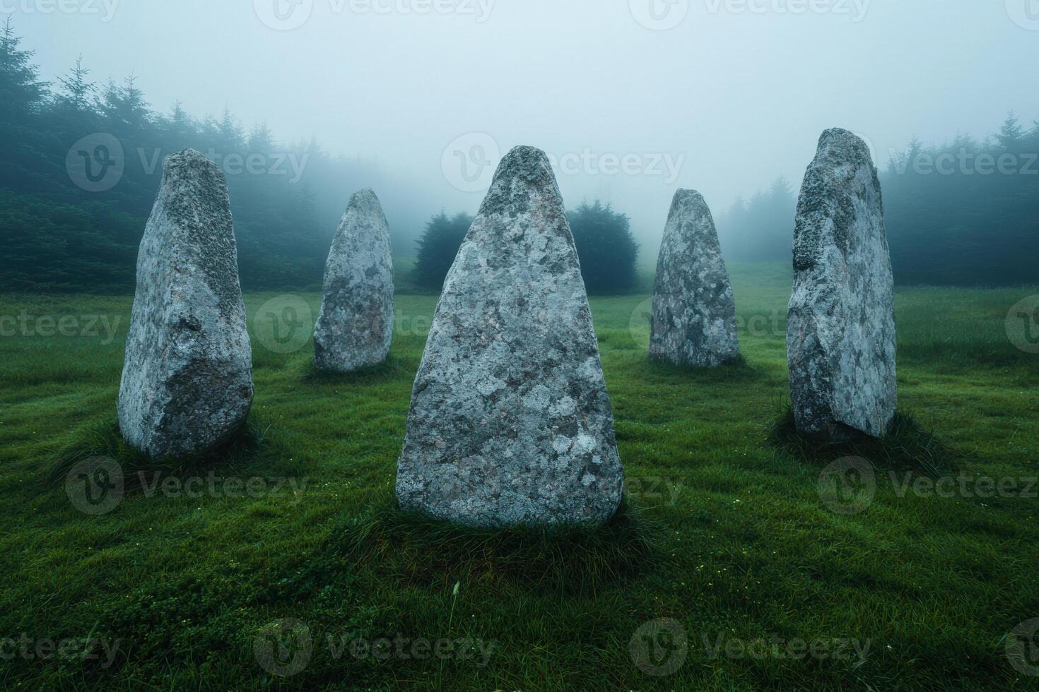 Mysterious stone monoliths in a misty forest landscape photo