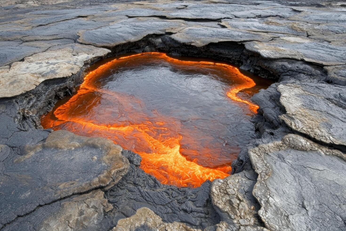 Glowing lava pool in volcanic landscape photo