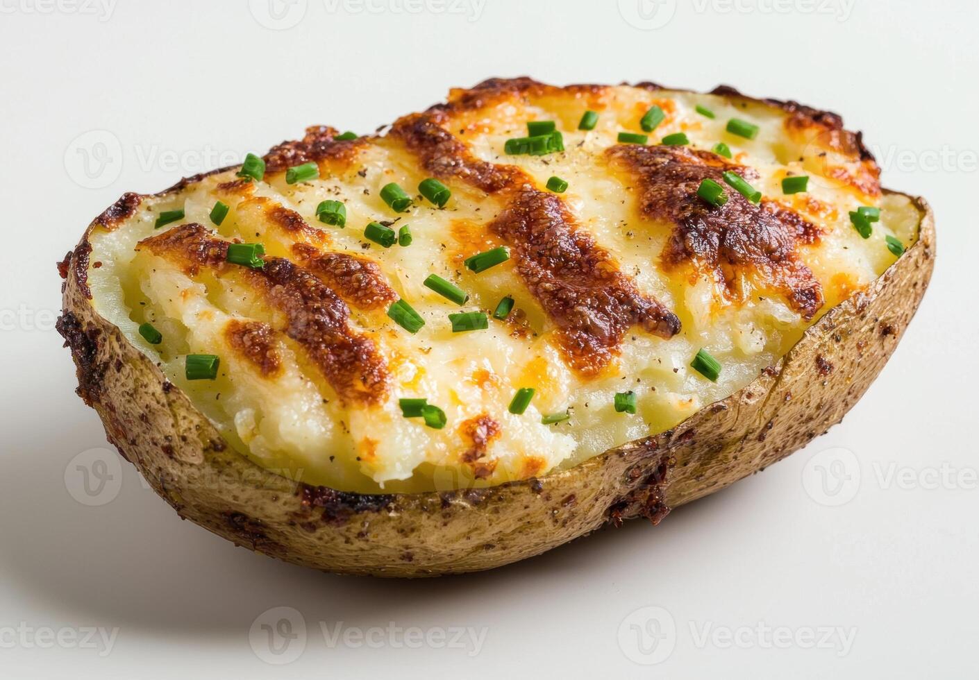 Baked potato with melted cheese and green onions photo