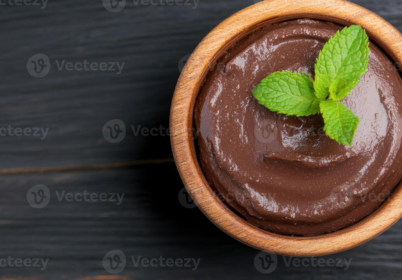 Delicious chocolate pudding dessert in wooden bowl photo