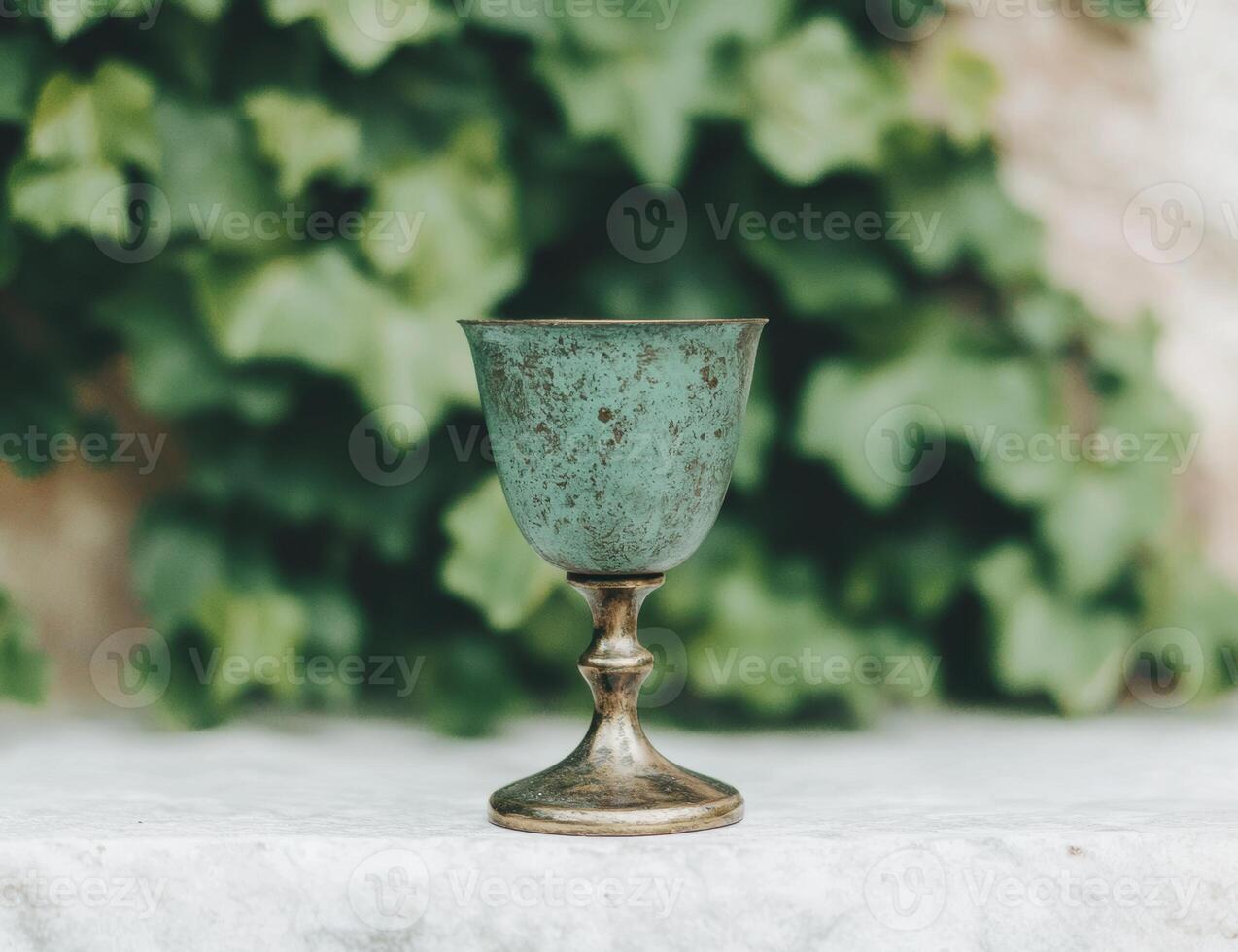 antique metal goblet in nature photo