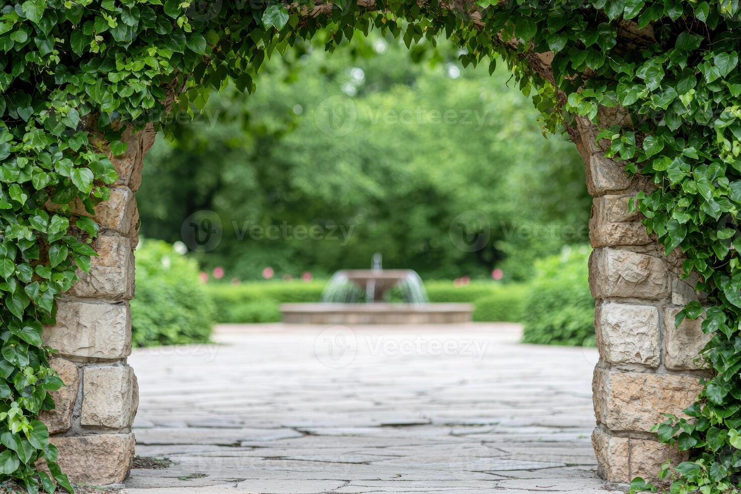 Lush garden path with stone archway and fountain photo