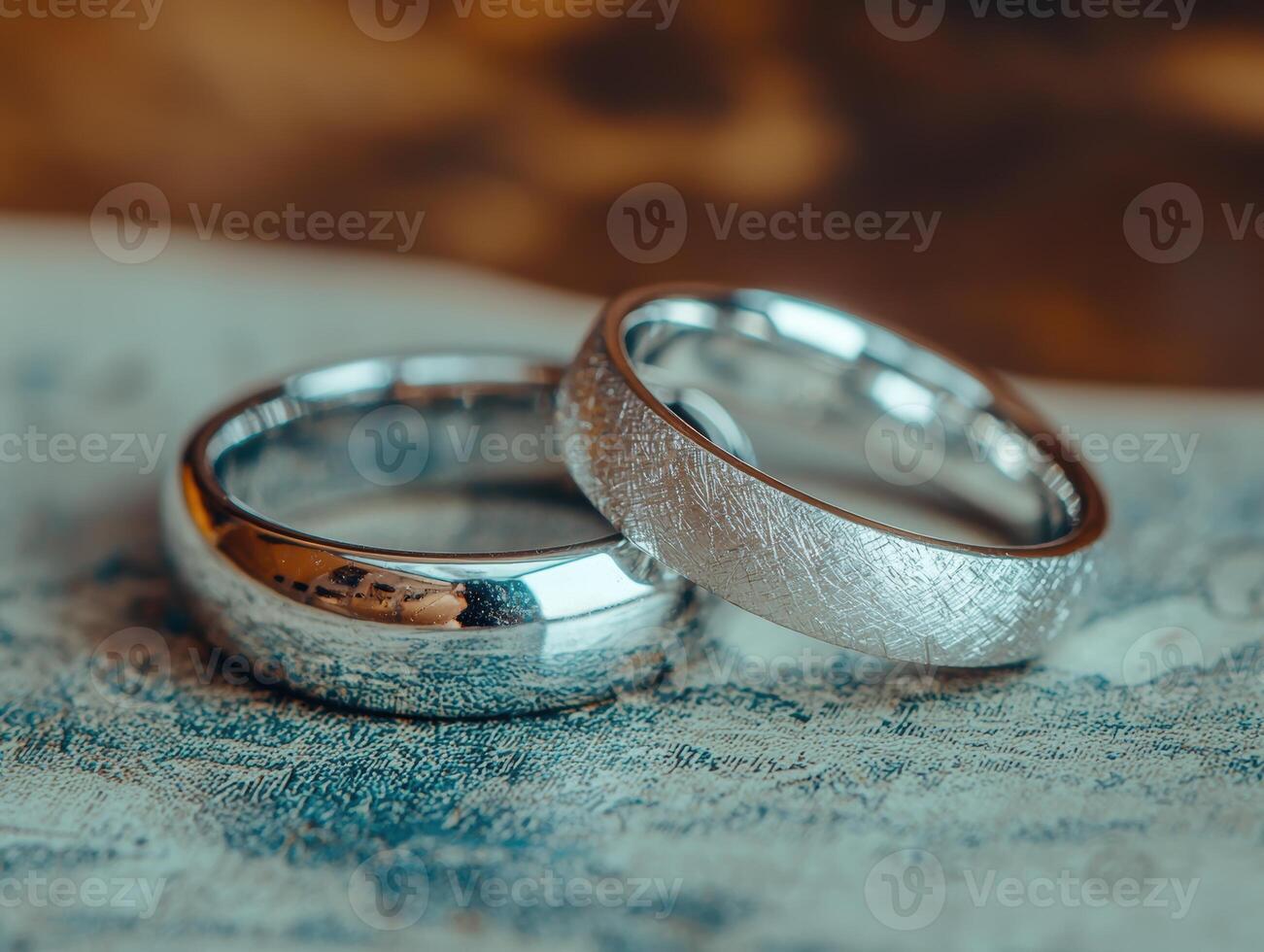 Elegant wedding rings on textured background photo