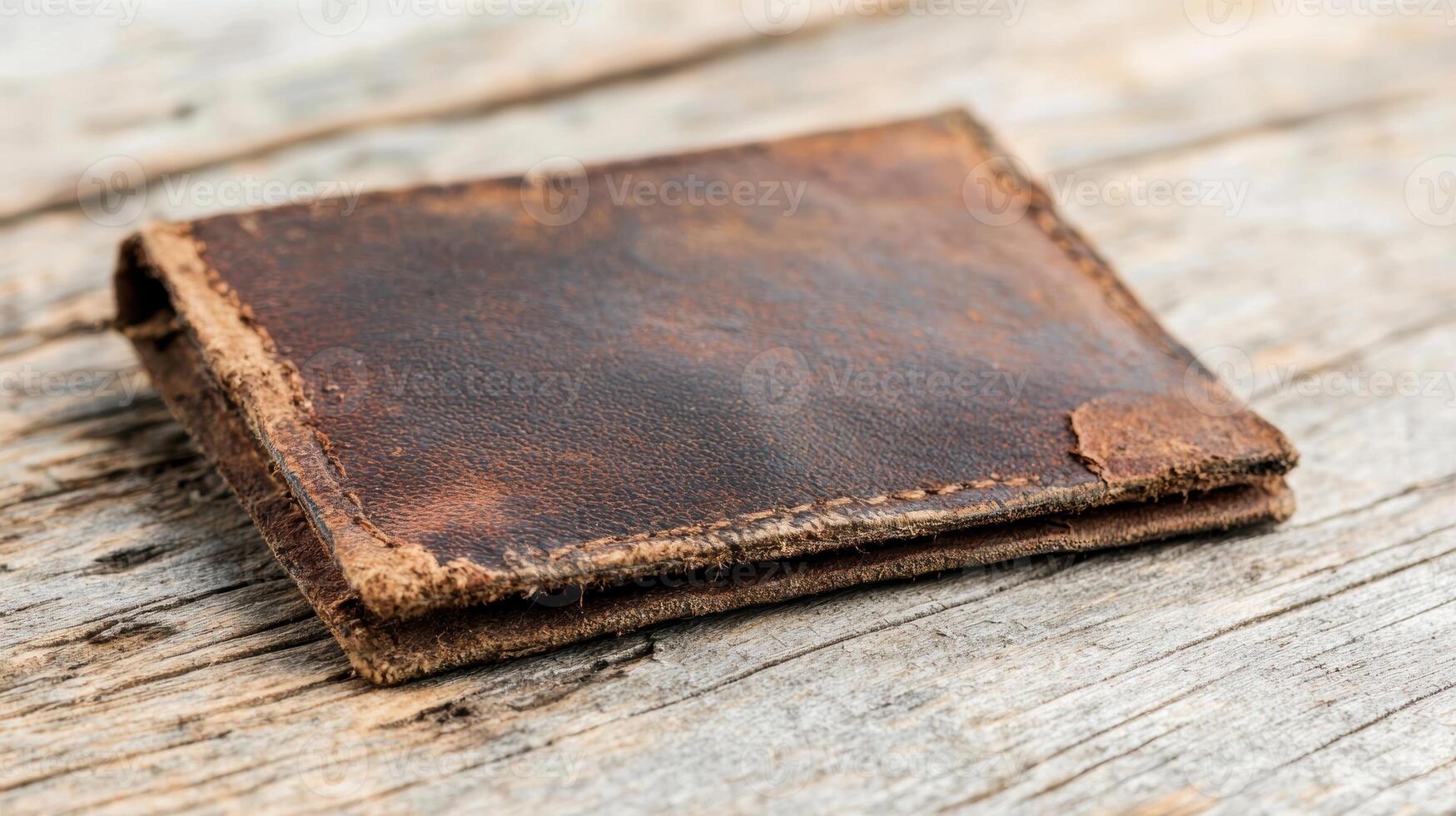 Vintage leather wallet on rustic wooden surface photo