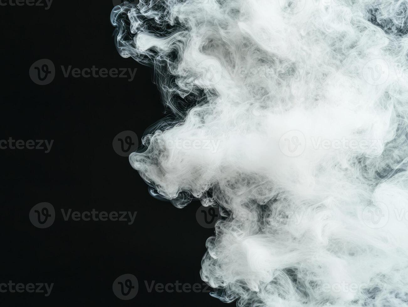Swirling clouds of white smoke against a dark background photo