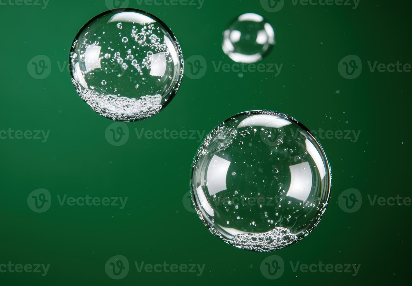 Floating glass bubbles on green background photo