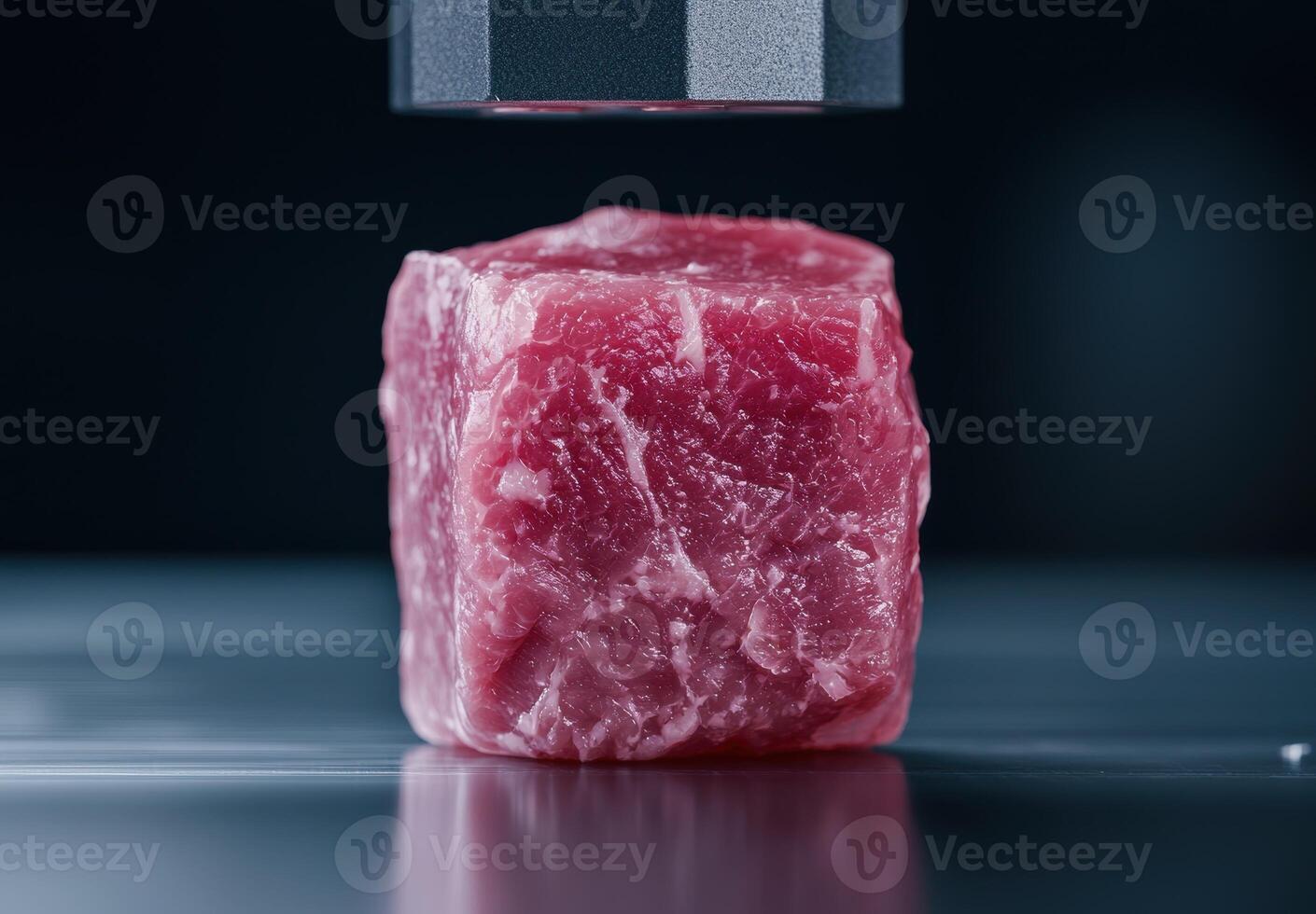 Closeup of raw red meat cube on dark background photo