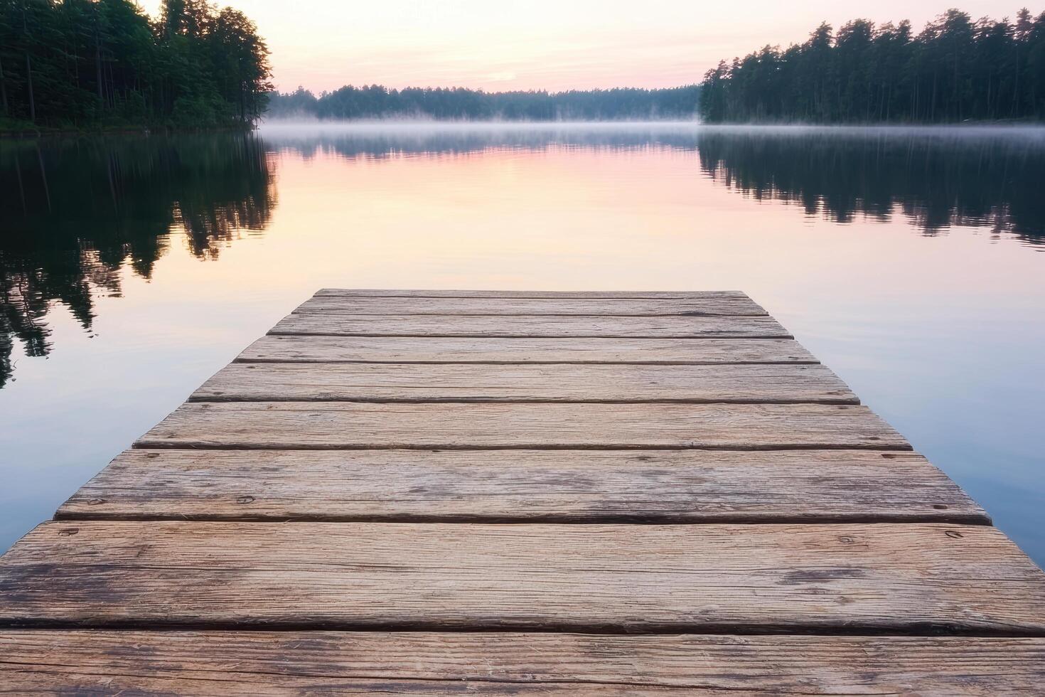 Serene lake with wooden dock at sunset photo