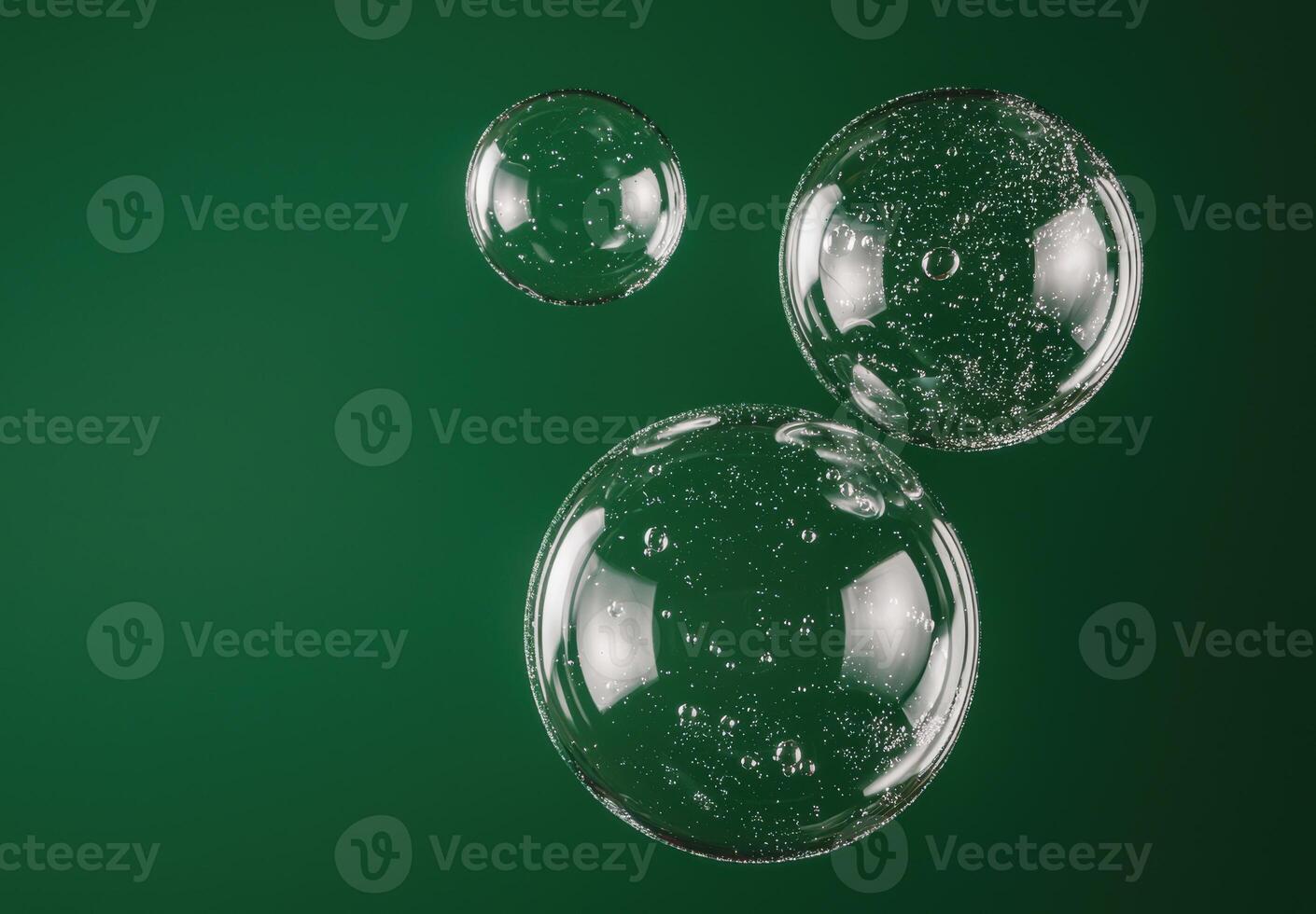 Transparent bubbles floating on green background photo