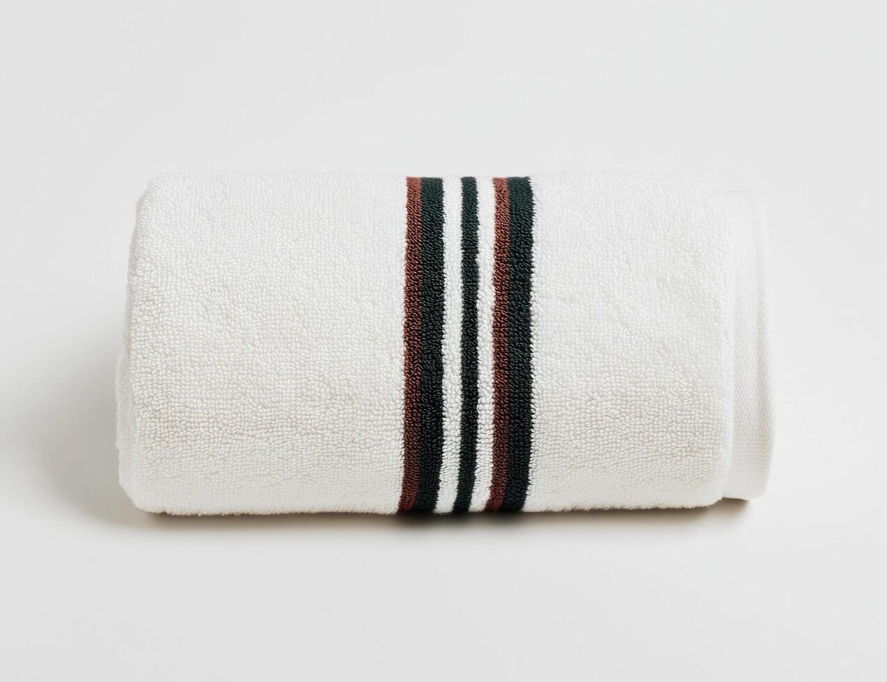 Folded white towel with striped pattern photo