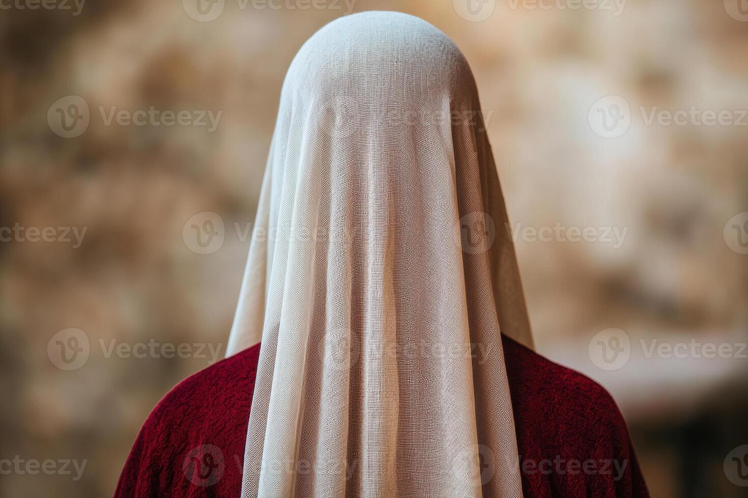 Mysterious figure in red robe and white veil photo