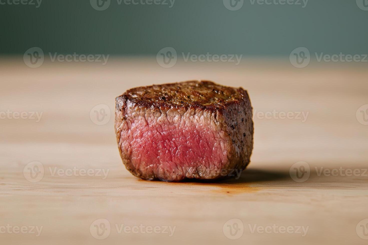 Perfectly cooked steak on wooden surface photo