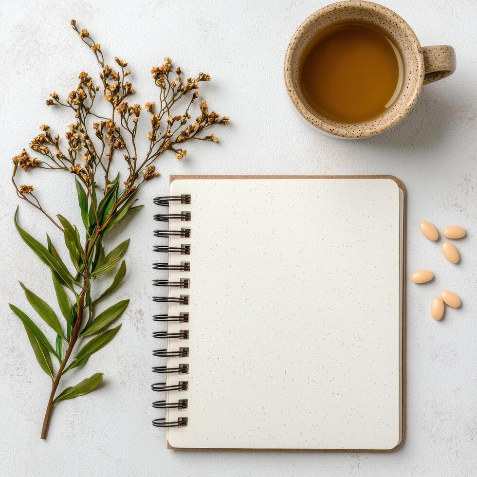 cozy workspace with notebook, tea, and flowers photo