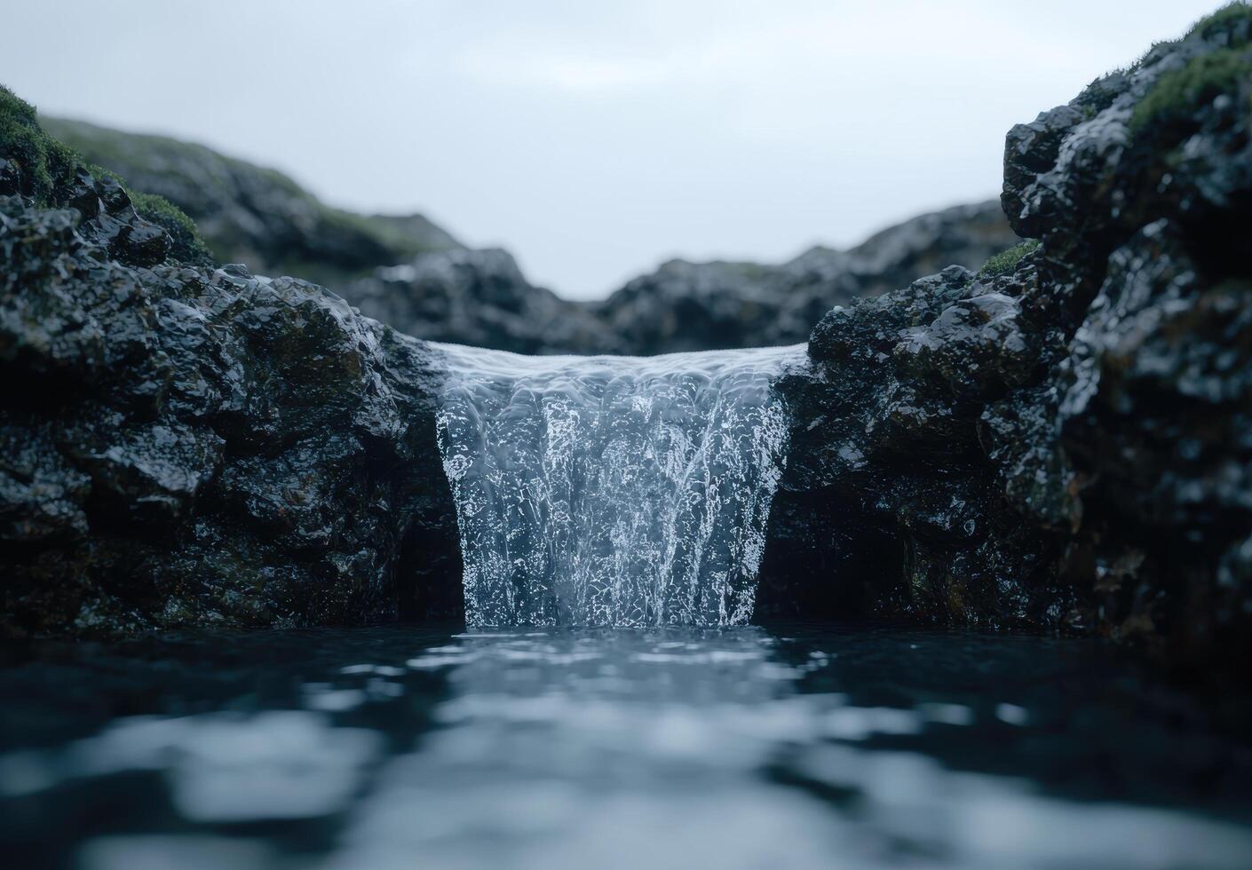 A waterfall flowing into a body of water photo