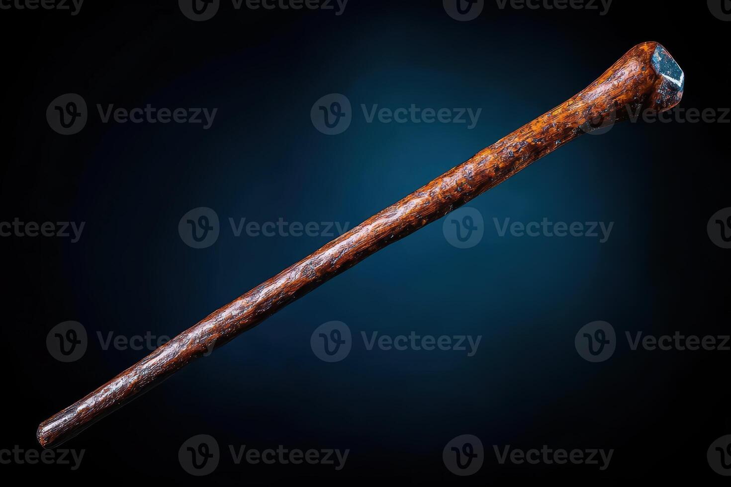 A long wooden stick with a black handle photo
