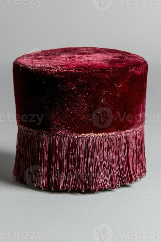 A red velvet hat with fringes on the top photo