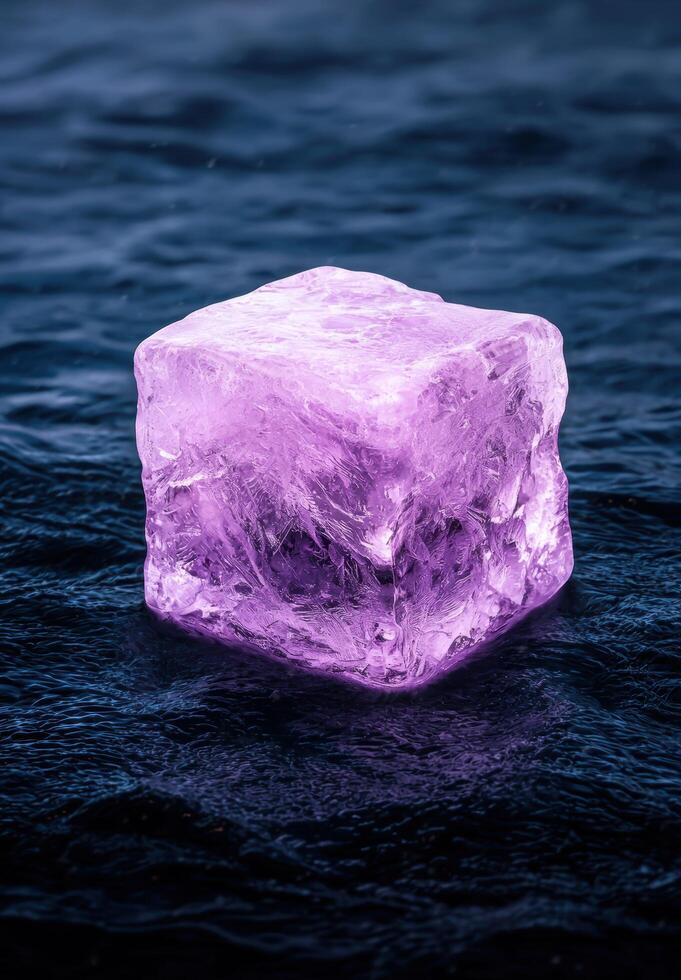 Glowing amethyst crystal in dark water photo