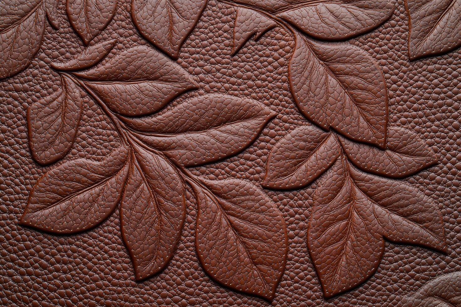 Detailed textured leather surface with intricate leaf pattern photo