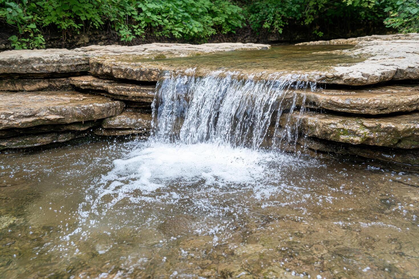 Serene waterfall cascading over rocky ledge photo