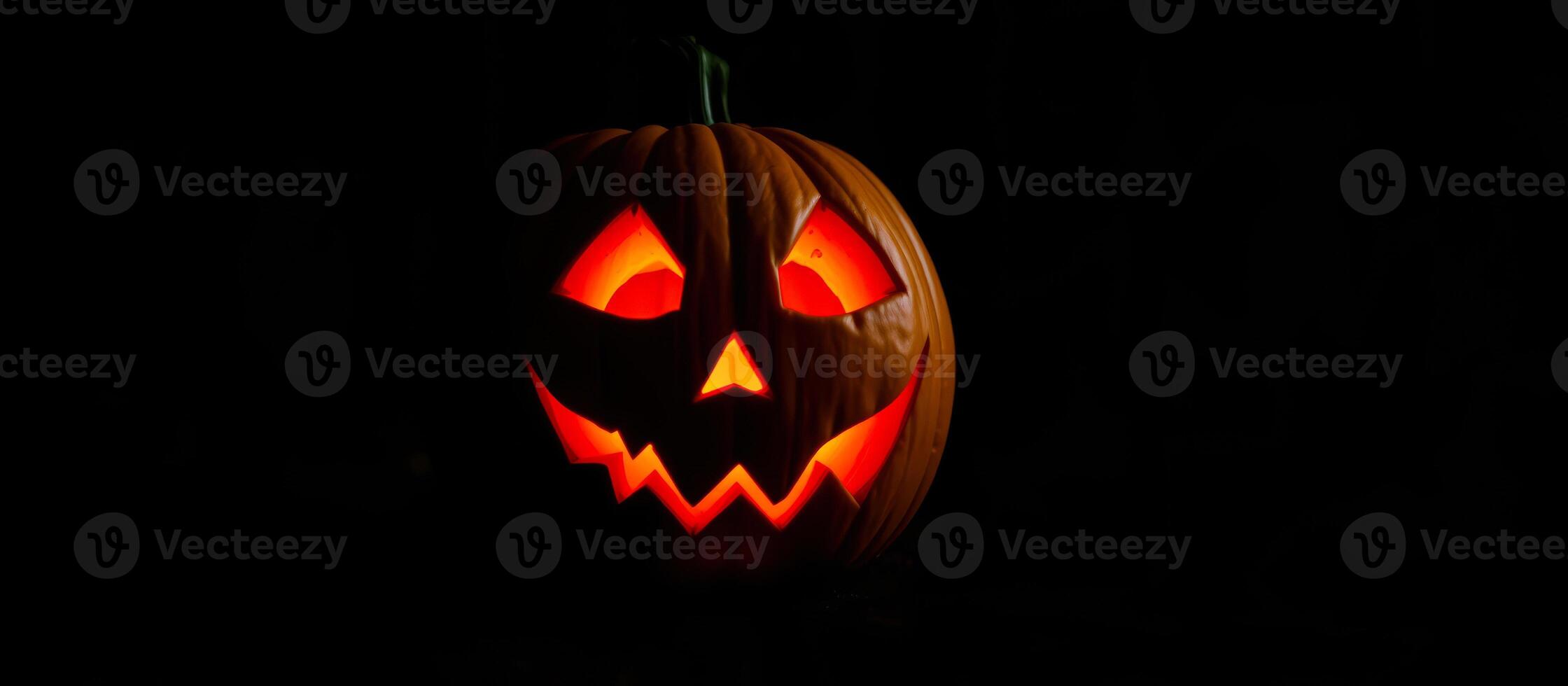 glowing carved pumpkin with a toothy grin photo