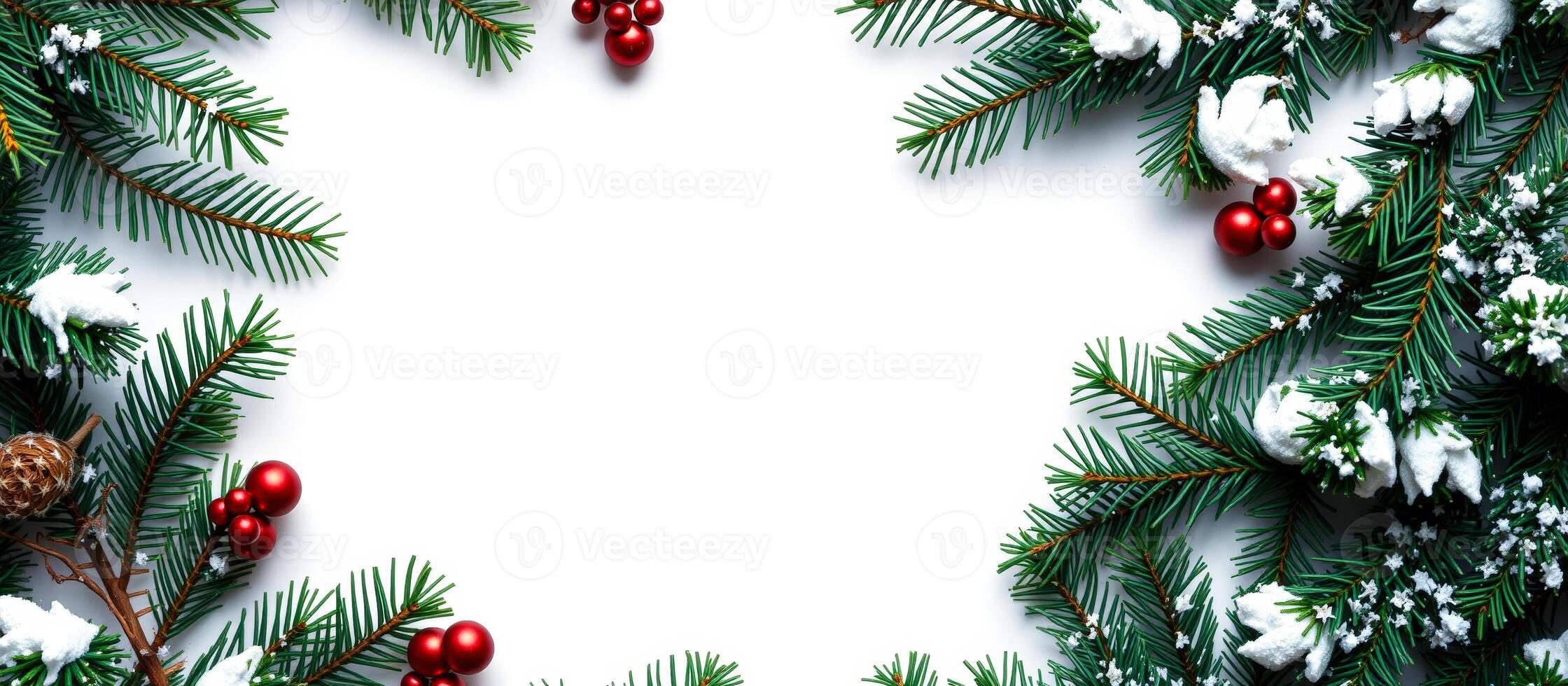 green pine branches with red ornaments faux snow form a festive frame photo