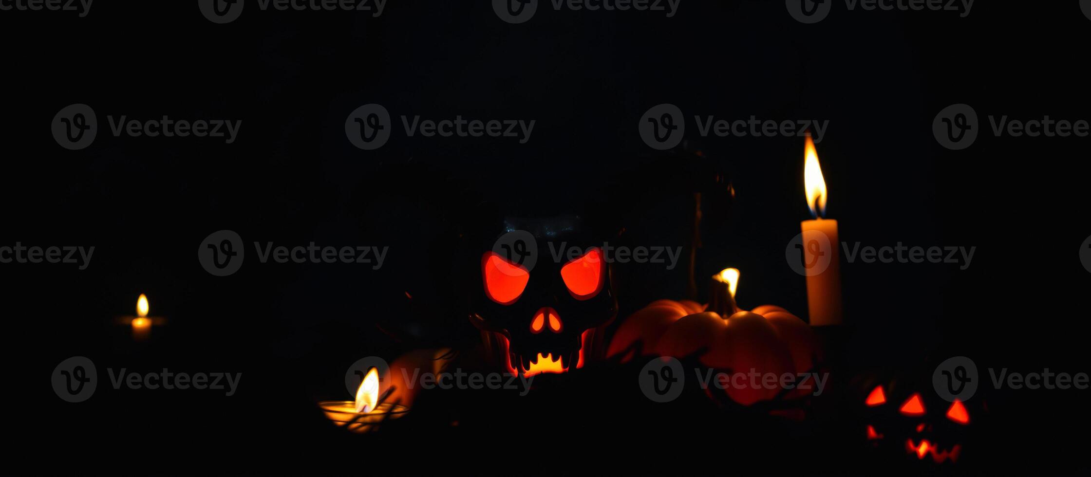 glowing skull with pumpkins candles photo