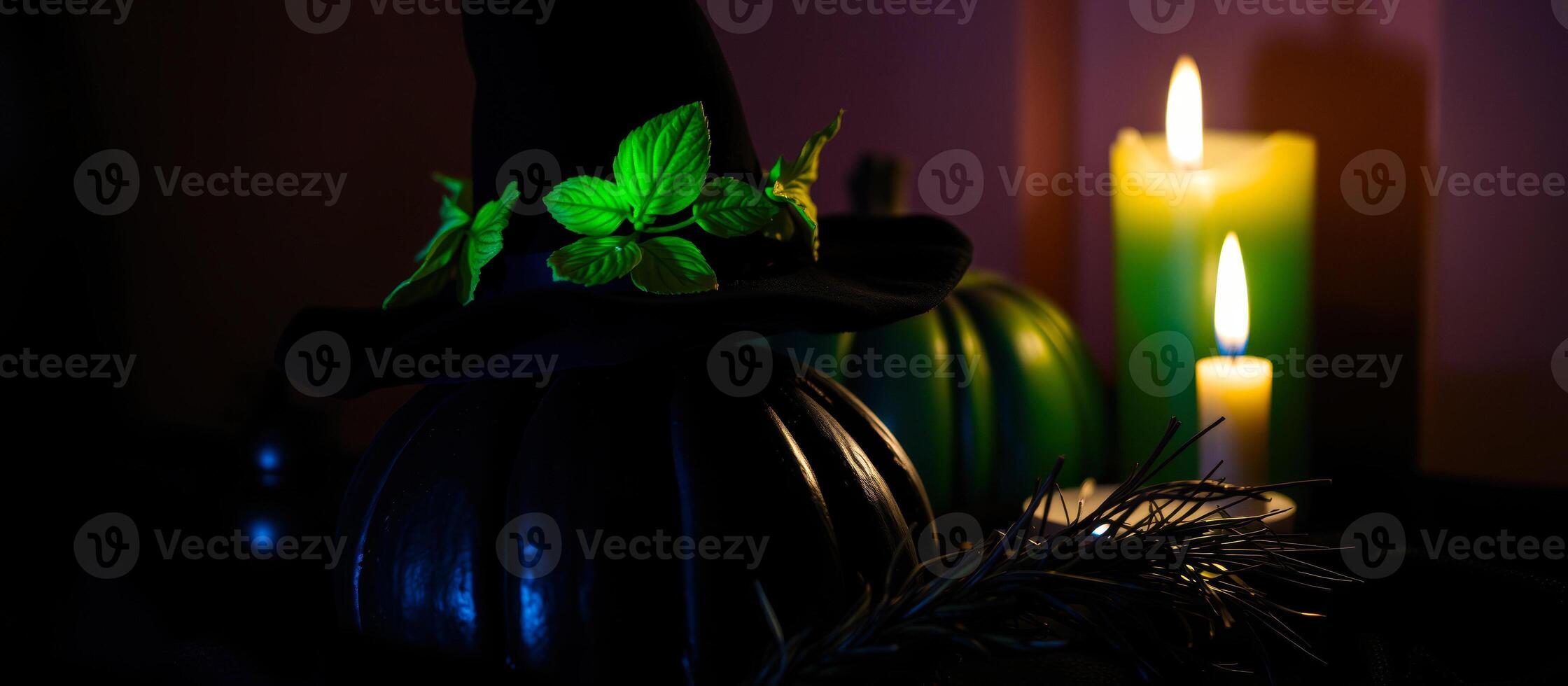 black pumpkin adorned with a witch's hat green leaves illuminated by candlelight photo