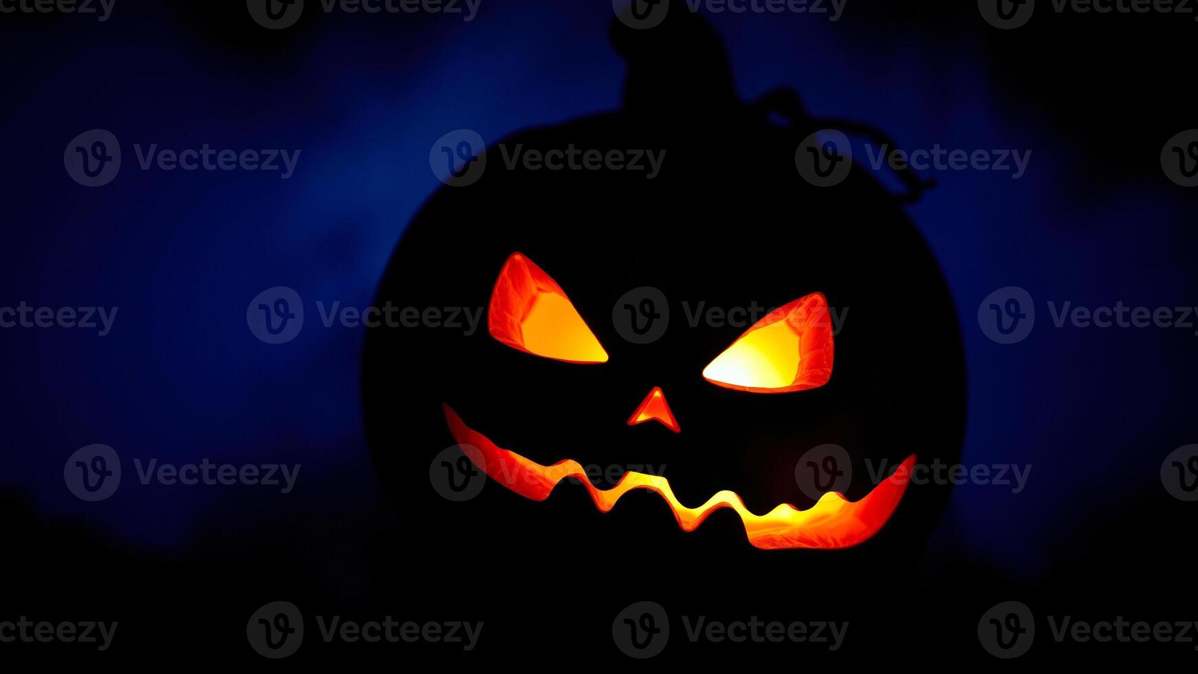 glowing carved pumpkin with a menacing grin photo