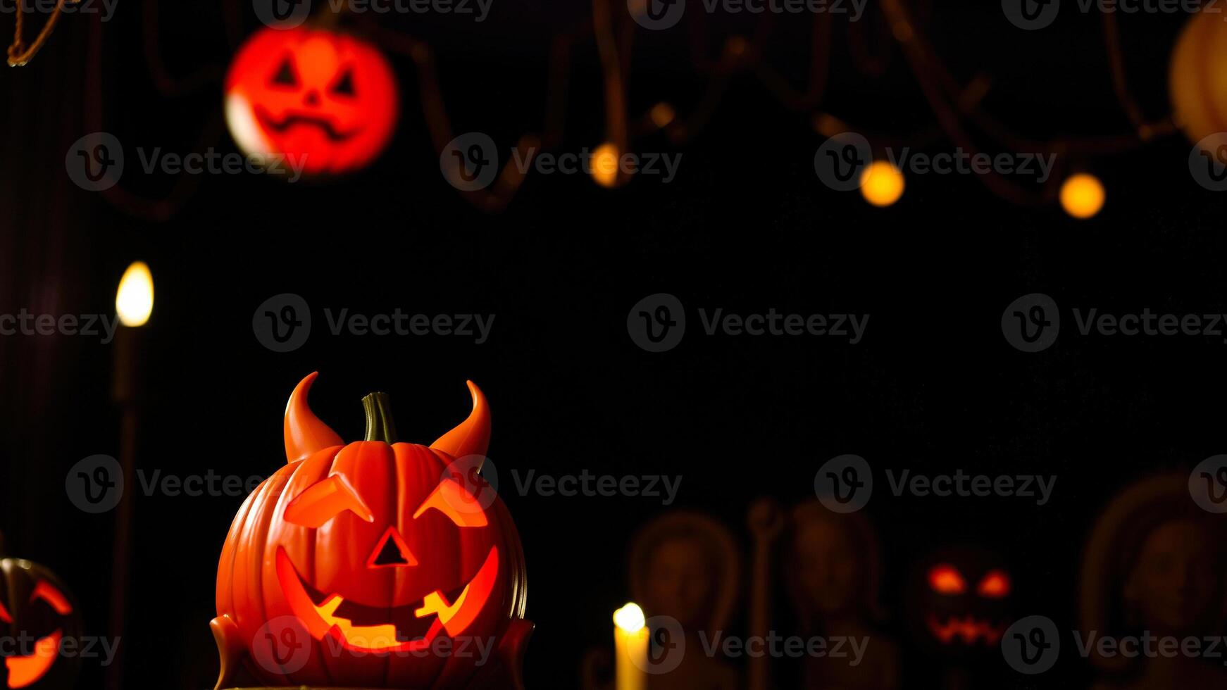 carved pumpkin with devil horns glows the dark photo