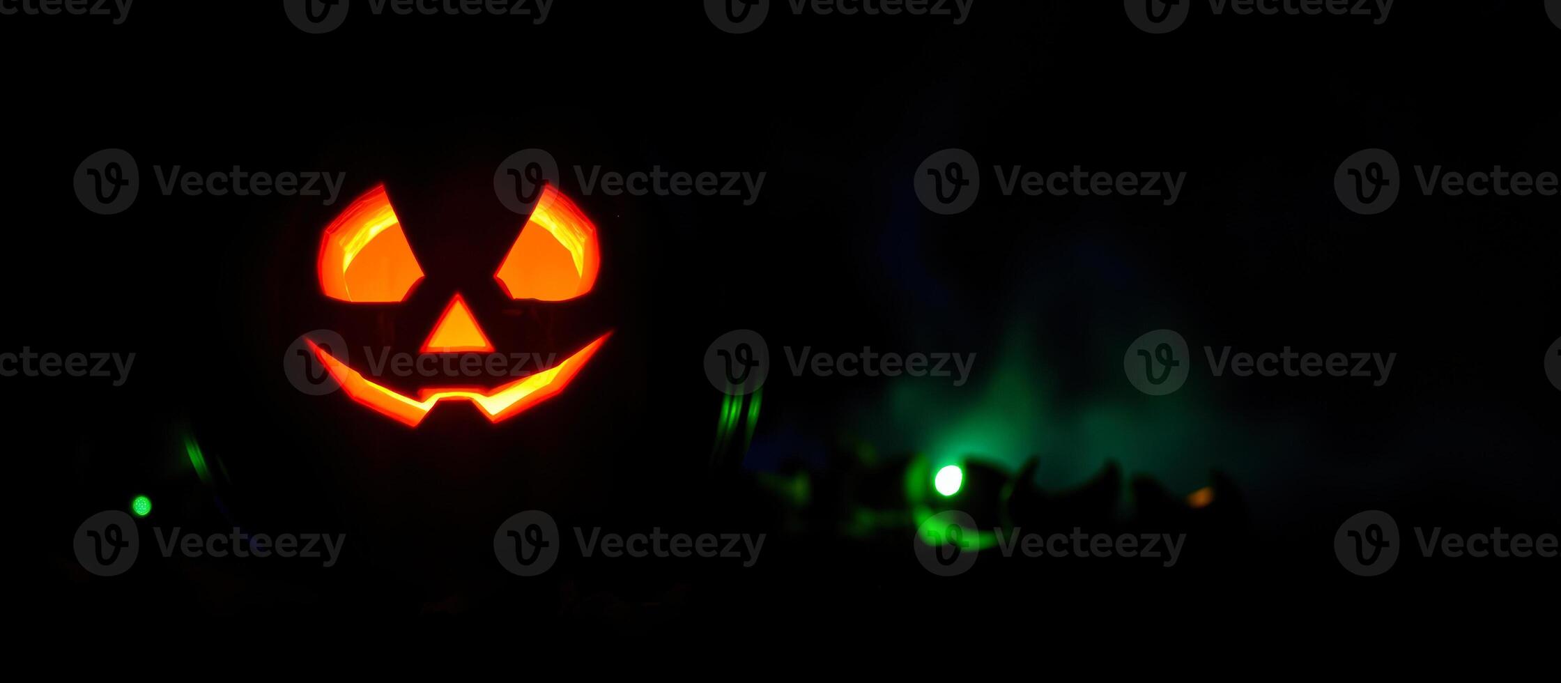 glowing carved pumpkin creates a spooky halloween atmosphere photo