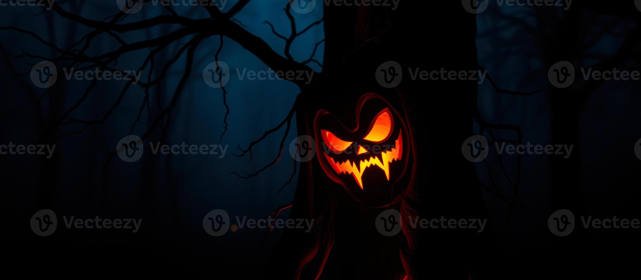 glowing jack-o'-lantern face hidden a dark forest photo