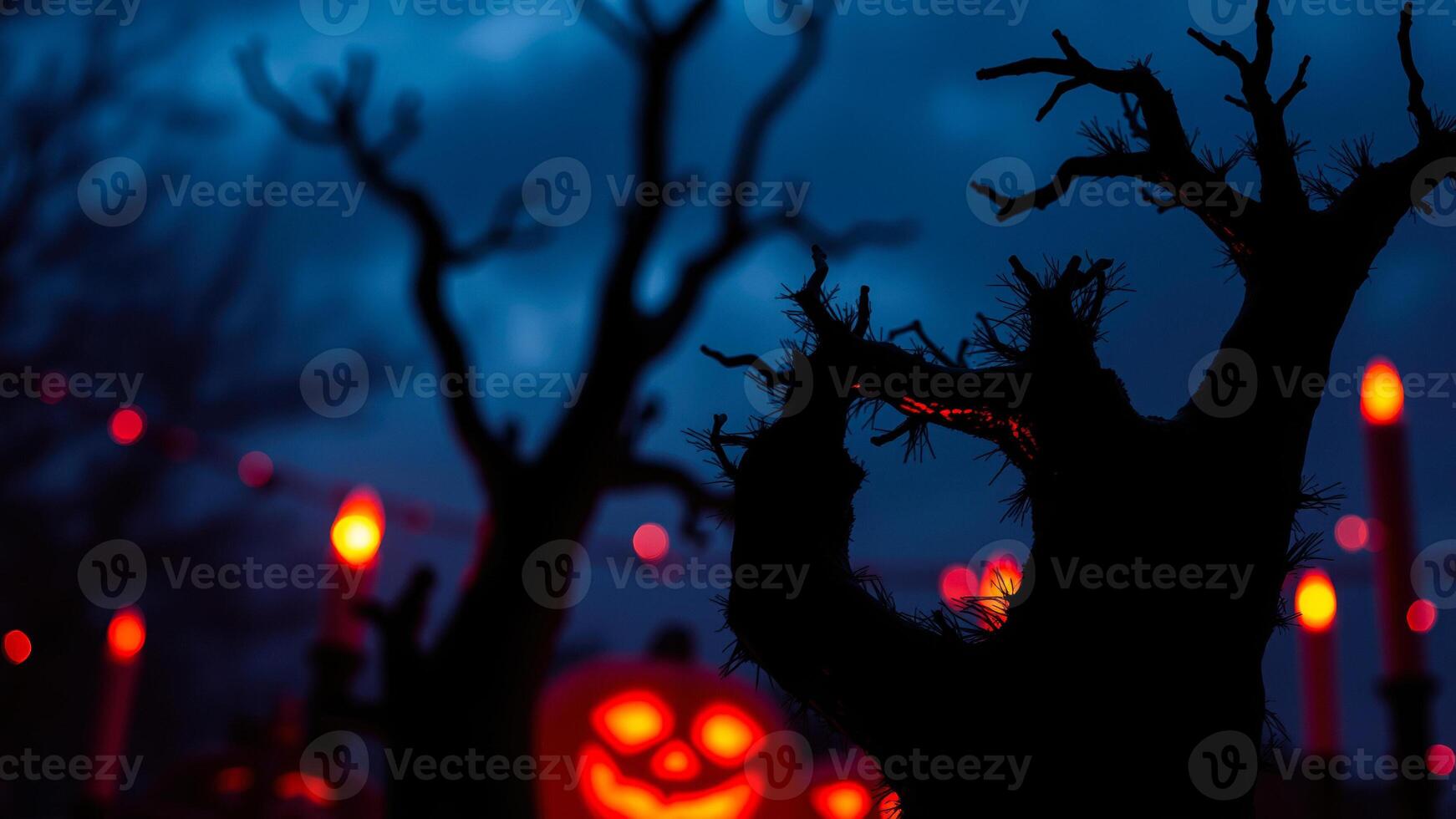 skeletal tree branch silhouetted against a blue evening sky photo