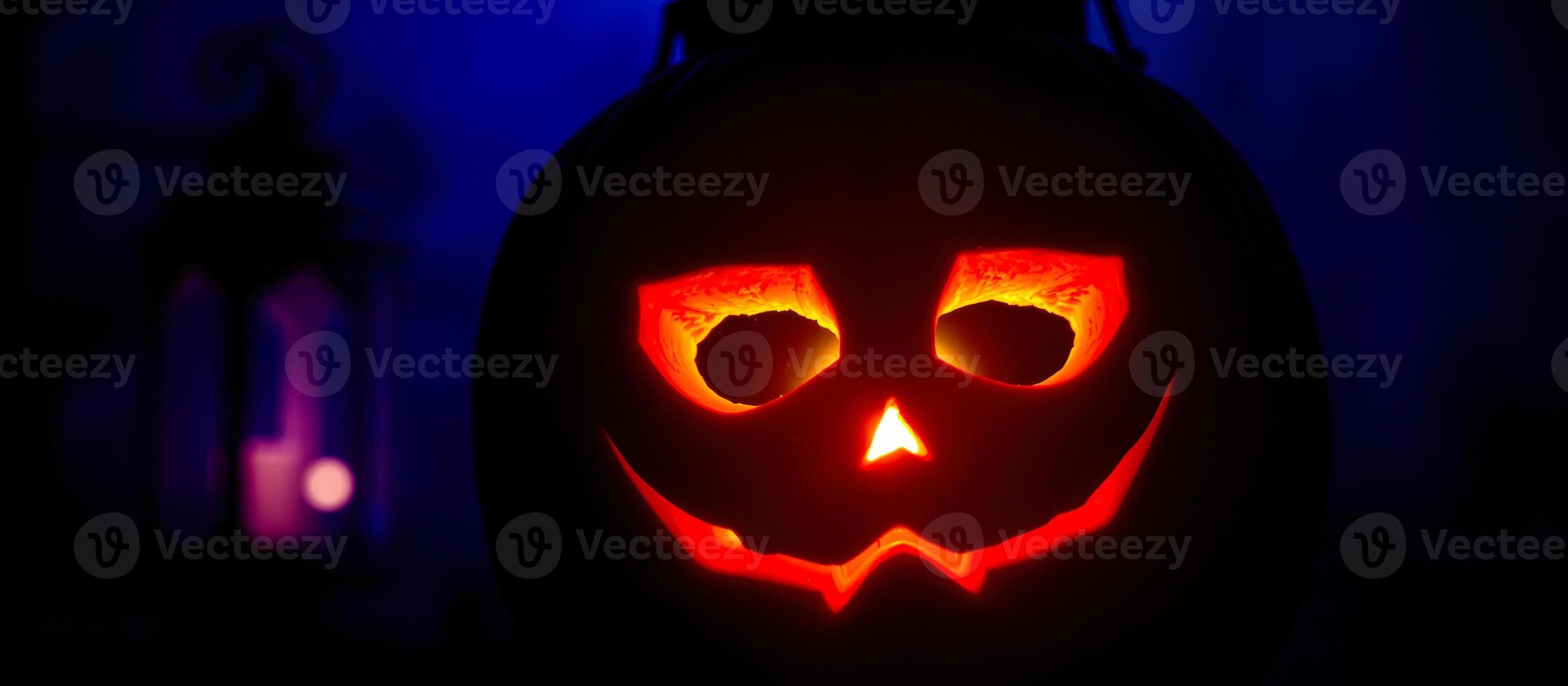glowing carved pumpkin with a wide grin photo