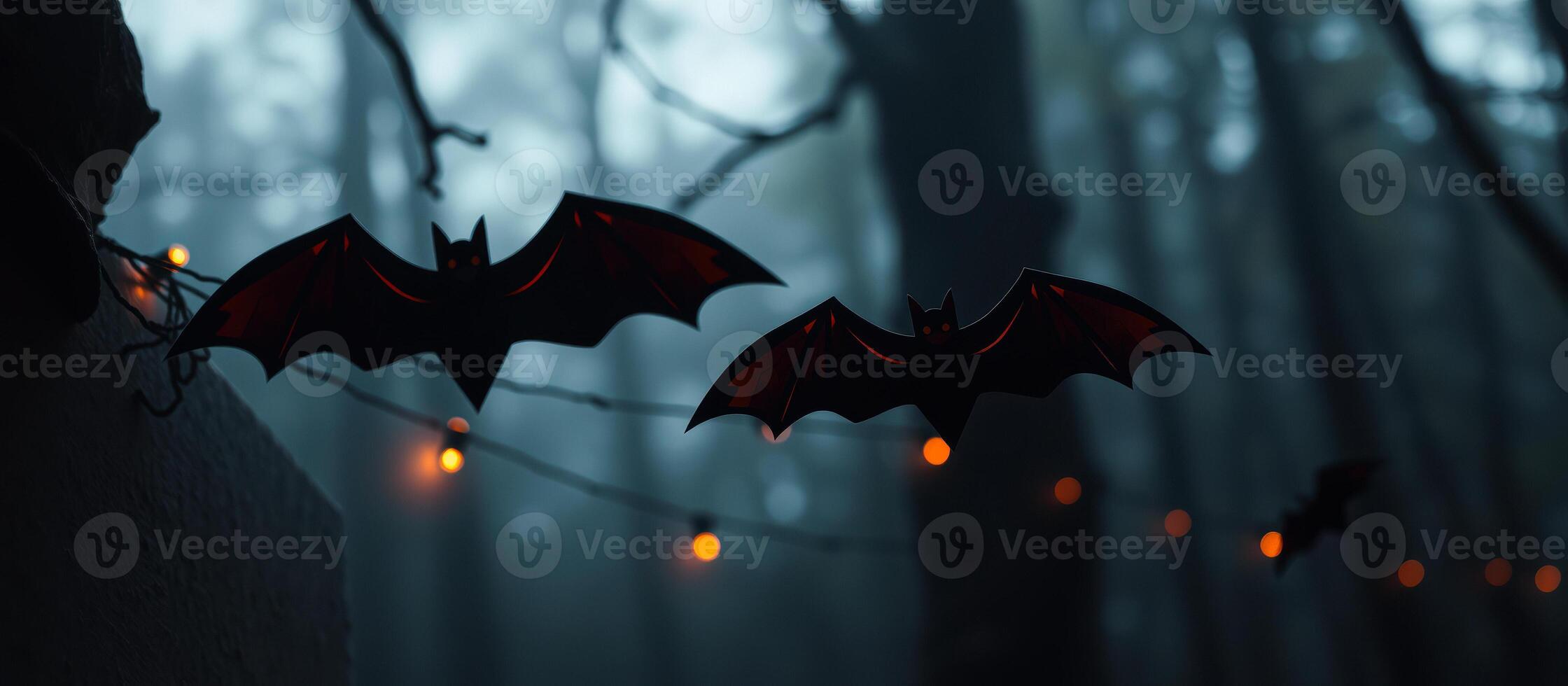 two bats hanging a foggy forest photo