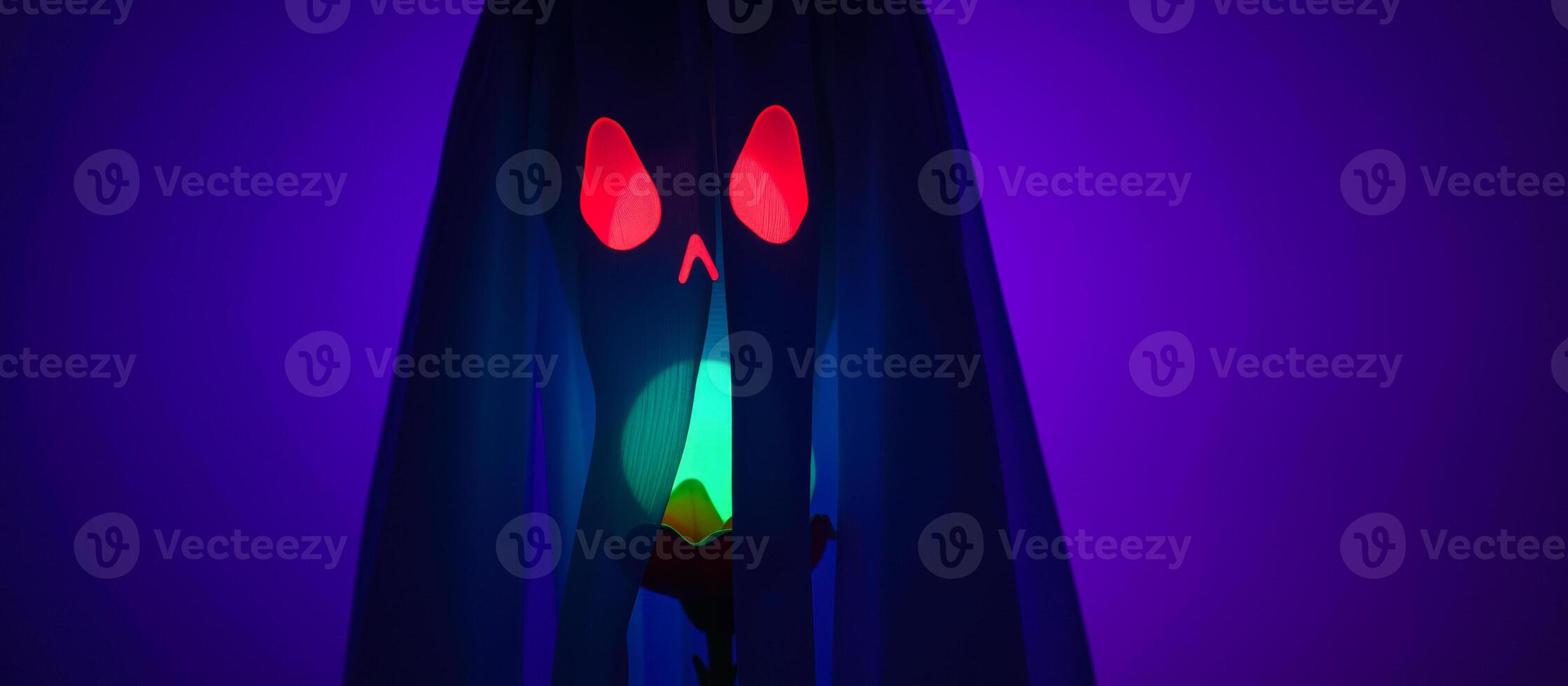glowing red eye peeking through a blue fabric photo