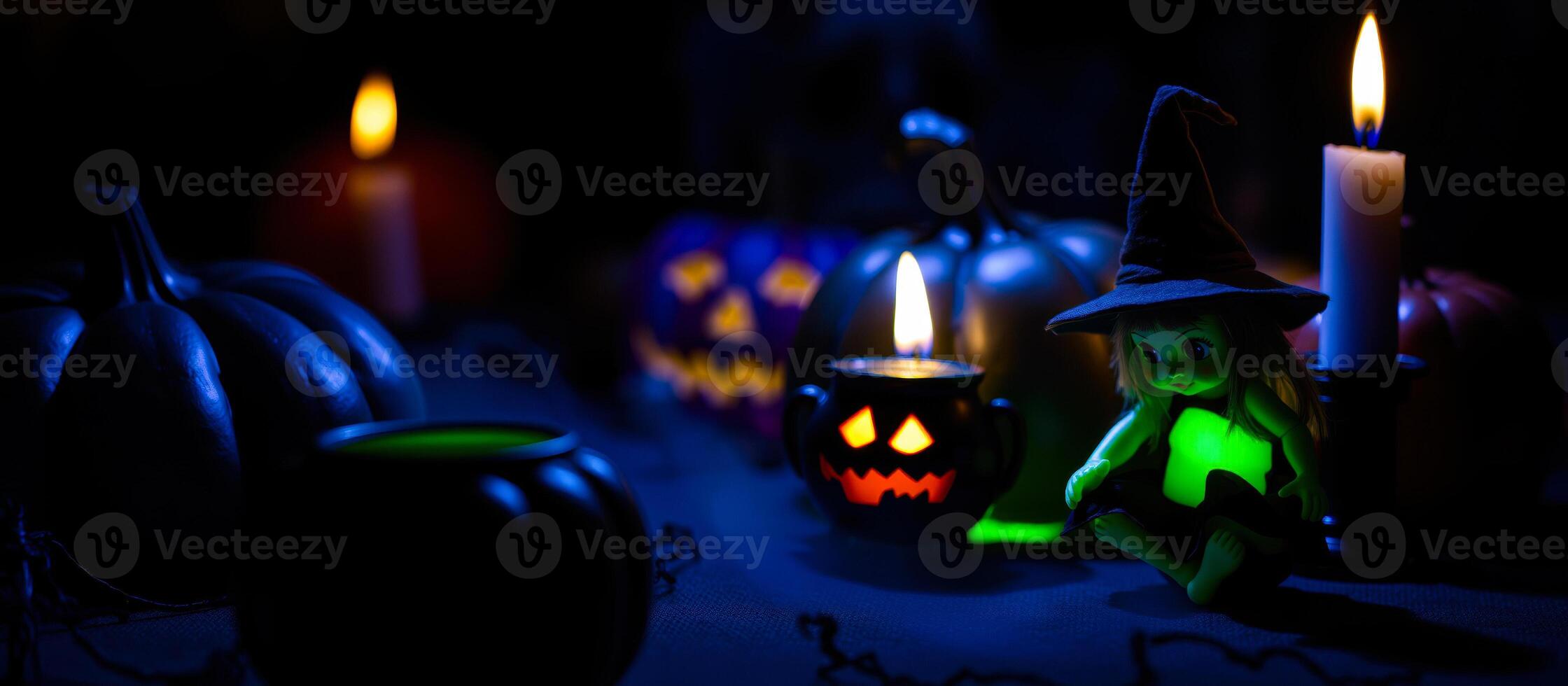 miniature witch doll amidst lit candles pumpkins photo